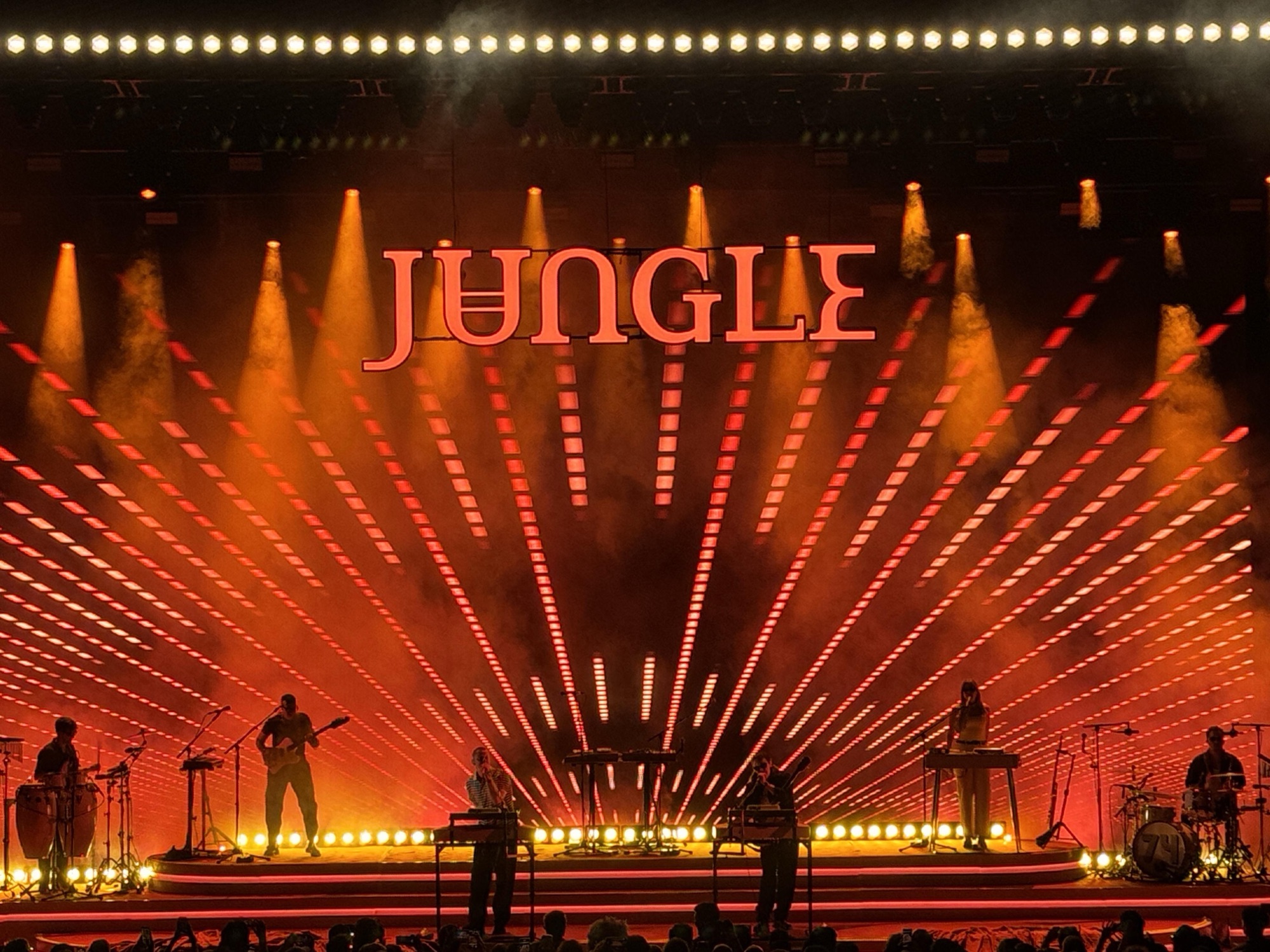 1000014829 LED video walls and blue stage lighting at a live event